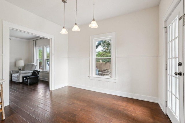 1916 Pecan St, Bastrop, TX 78602 - unfurnished room with healthy amount of natural light, dark wood-style flooring, and a wainscoted wall