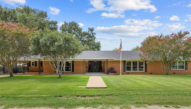 view of front facade featuring crawl space, a front yard, and brick siding