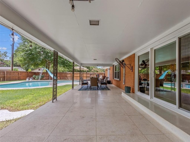 fenced backyard with a patio and outdoor dining space