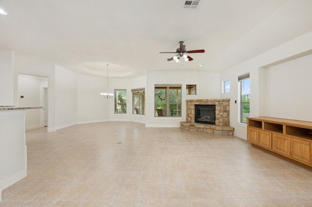 105 Outcrop View Ln, Austin, TX 78738 - unfurnished living room featuring ceiling fan, light tile patterned floors, a chandelier, and a stone fireplace