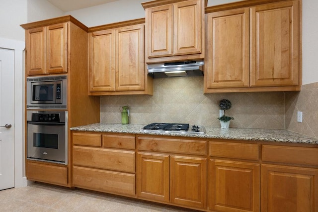 105 Outcrop View Ln, Austin, TX 78738 - kitchen featuring stainless steel appliances, light stone counters, decorative backsplash, and under cabinet range hood