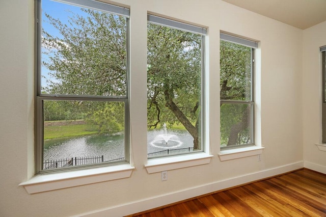 105 Outcrop View Ln, Austin, TX 78738 - spare room featuring wood finished floors and a water view