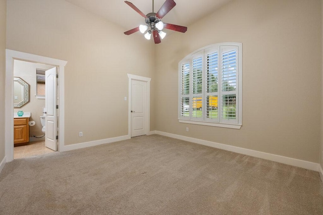105 Outcrop View Ln, Austin, TX 78738 - unfurnished bedroom with high vaulted ceiling, light colored carpet, connected bathroom, and ceiling fan