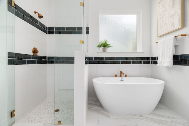 352 Moonlit Stream Pass, Dripping Springs, TX 78620 - bathroom with a shower stall, a freestanding bath, marble finish floors, and tile walls