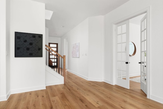 352 Moonlit Stream Pass, Dripping Springs, TX 78620 - spare room featuring light wood-style floors and stairs
