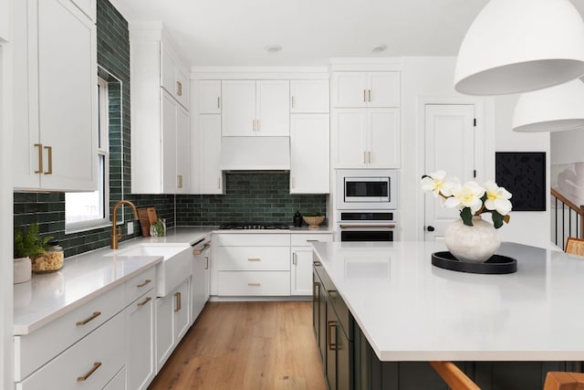 352 Moonlit Stream Pass, Dripping Springs, TX 78620 - kitchen with white appliances, white cabinetry, and light wood-style flooring
