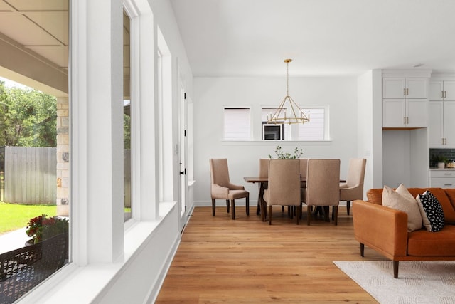 352 Moonlit Stream Pass, Dripping Springs, TX 78620 - dining area featuring a chandelier, healthy amount of natural light, and light wood-style flooring