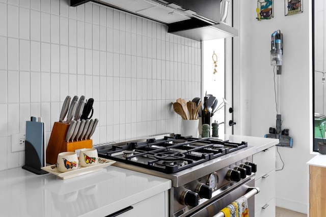 5509 Clay Ave Unit 2, Austin, TX 78756 - kitchen with stainless steel range, custom range hood, backsplash, and white cabinetry