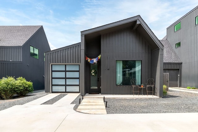 5509 Clay Ave Unit 2, Austin, TX 78756 - modern inspired farmhouse with concrete driveway, an attached garage, a shingled roof, and board and batten siding