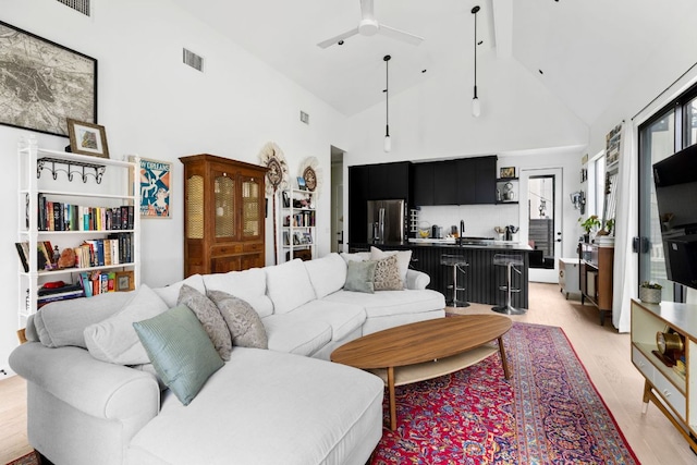 5509 Clay Ave Unit 2, Austin, TX 78756 - living area featuring high vaulted ceiling, ceiling fan, light wood finished floors, and beamed ceiling