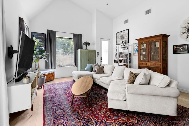 5509 Clay Ave Unit 2, Austin, TX 78756 - living room featuring high vaulted ceiling and wood finished floors