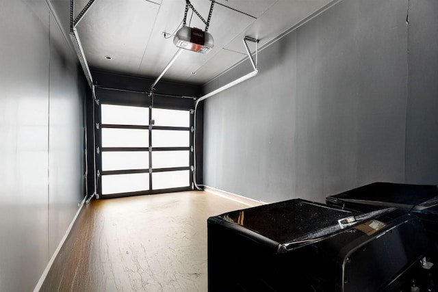 5509 Clay Ave Unit 2, Austin, TX 78756 - garage with a garage door opener and baseboards