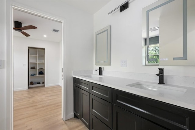 1101 Floradale Dr, Austin, TX 78753 - full bathroom featuring double vanity, wood finished floors, a ceiling fan, and recessed lighting