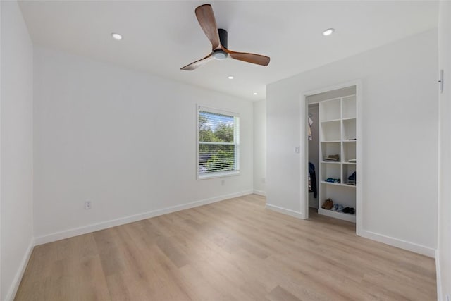 1101 Floradale Dr, Austin, TX 78753 - unfurnished bedroom with light wood-type flooring, recessed lighting, ceiling fan, and a walk in closet