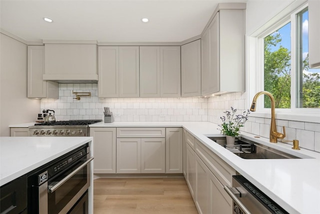 1101 Floradale Dr, Austin, TX 78753 - kitchen featuring appliances with stainless steel finishes, light countertops, decorative backsplash, and recessed lighting