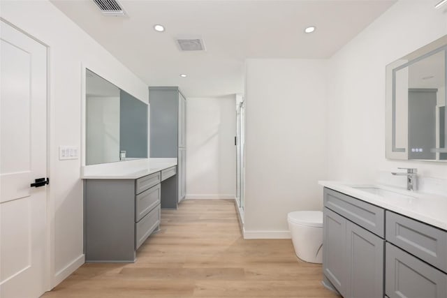 1101 Floradale Dr, Austin, TX 78753 - bathroom featuring two vanities, wood finished floors, recessed lighting, and an enclosed shower