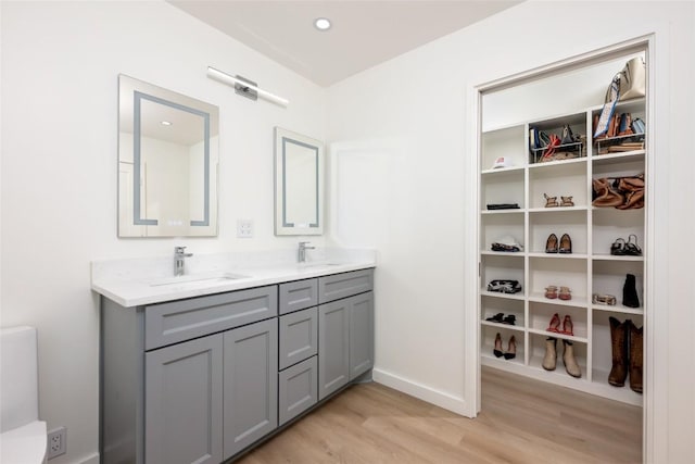 1101 Floradale Dr, Austin, TX 78753 - full bathroom featuring wood finished floors and double vanity