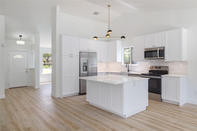 2502 W Messick Loop, Round Rock, TX 78681 - kitchen with stainless steel appliances, backsplash, light countertops, light wood-style flooring, and high vaulted ceiling