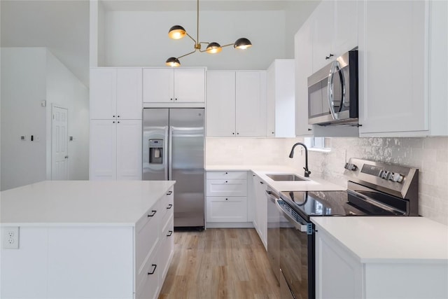 2502 W Messick Loop, Round Rock, TX 78681 - kitchen with stainless steel appliances, light wood-type flooring, decorative backsplash, white cabinets, and light countertops