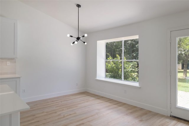 2502 W Messick Loop, Round Rock, TX 78681 - unfurnished dining area with a chandelier and light wood-style floors