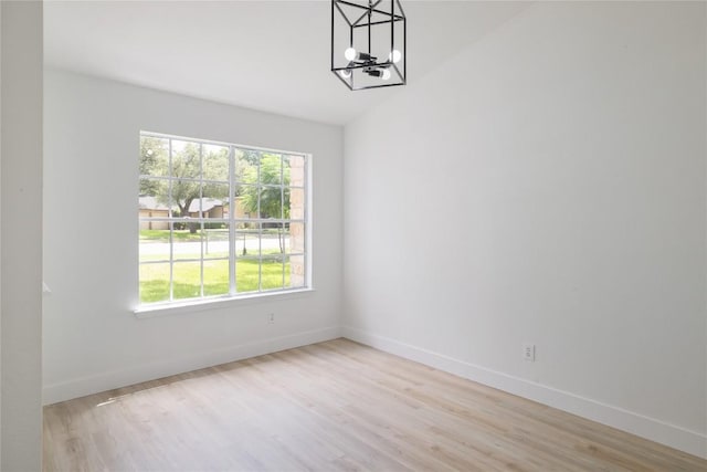 2502 W Messick Loop, Round Rock, TX 78681 - unfurnished room with a chandelier, light wood-style floors, and vaulted ceiling