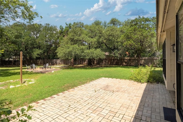 2502 W Messick Loop, Round Rock, TX 78681 - fenced backyard featuring a fire pit, a patio area, and view of scattered trees