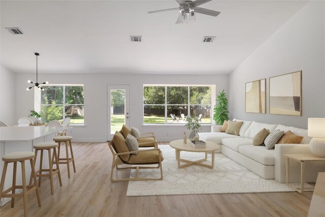 2502 W Messick Loop, Round Rock, TX 78681 - living room featuring light wood finished floors, plenty of natural light, a chandelier, and ceiling fan