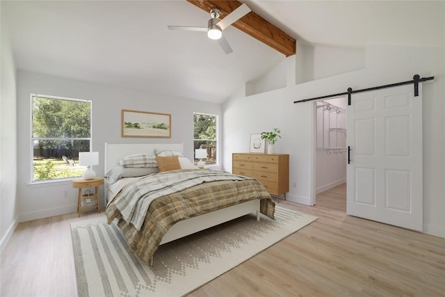 2502 W Messick Loop, Round Rock, TX 78681 - bedroom featuring a barn door, beam ceiling, light wood-type flooring, a ceiling fan, and high vaulted ceiling