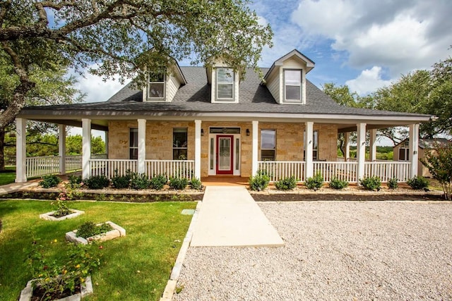 15020 Hero Way W, Leander, TX 78641 - farmhouse-style home featuring covered porch, stone siding, a front lawn, and a shingled roof