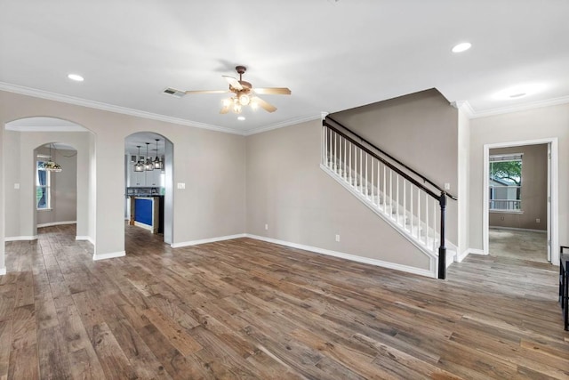 15020 Hero Way W, Leander, TX 78641 - unfurnished living room featuring arched walkways, ceiling fan, wood finished floors, stairway, and recessed lighting