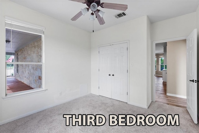 15020 Hero Way W, Leander, TX 78641 - unfurnished bedroom with carpet flooring, a closet, and a ceiling fan