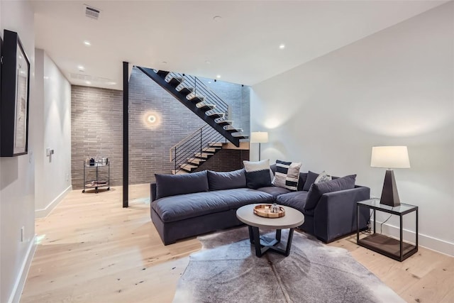 1315 W 9th St Unit B, Austin, TX 78703 - living room featuring light wood-style floors, stairs, and brick wall