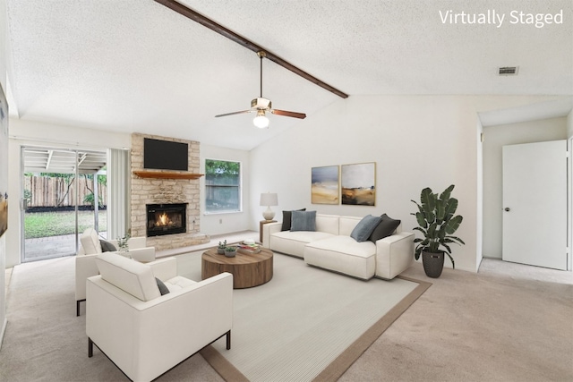 12404 Wycliff Ln, Austin, TX 78727 - living room with light carpet, a textured ceiling, a ceiling fan, and a fireplace