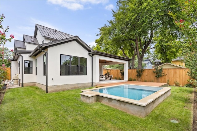 1703 Madison, Austin, TX 78757 - back of property with a fenced backyard, stucco siding, and a patio