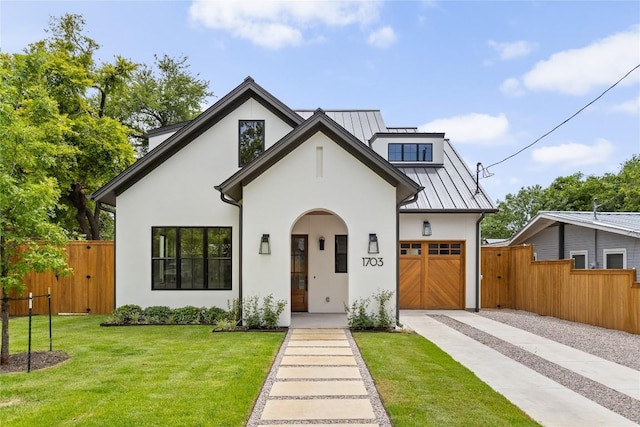 1703 Madison, Austin, TX 78757 - view of front facade featuring driveway, a standing seam roof, stucco siding, and a metal roof