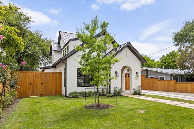 1703 Madison, Austin, TX 78757 - tudor home featuring stucco siding, a standing seam roof, a metal roof, and a gate