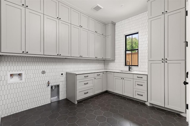 1703 Madison, Austin, TX 78757 - laundry area with cabinet space, gas dryer hookup, dark tile patterned floors, and electric dryer hookup