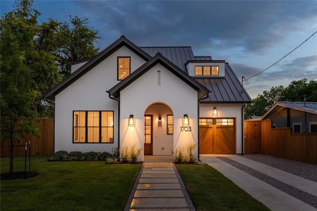 1703 Madison, Austin, TX 78757 - view of front of home with driveway, a standing seam roof, stucco siding, an attached garage, and a metal roof