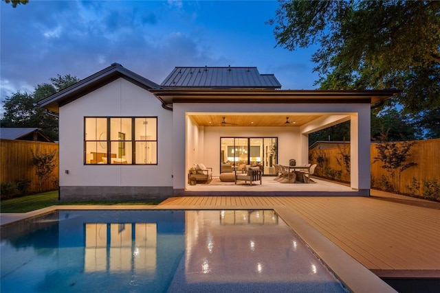 1703 Madison, Austin, TX 78757 - back of property featuring a standing seam roof, a deck, stucco siding, and a metal roof