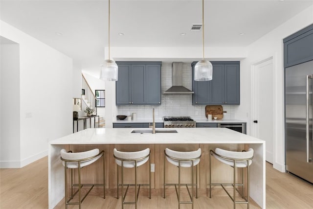 1703 Madison, Austin, TX 78757 - kitchen with wall chimney range hood, built in refrigerator, backsplash, and light wood-type flooring