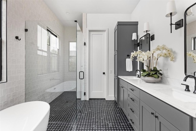 1703 Madison, Austin, TX 78757 - full bath featuring a shower stall, double vanity, a freestanding tub, and tile patterned floors