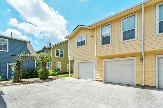 1601 Miriam Ave Unit 100, Austin, TX 78702 - view of property with an attached garage and asphalt driveway