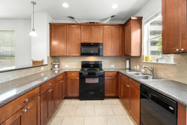 1601 Miriam Ave Unit 100, Austin, TX 78702 - kitchen featuring black appliances, brown cabinets, decorative light fixtures, light tile patterned floors, and recessed lighting