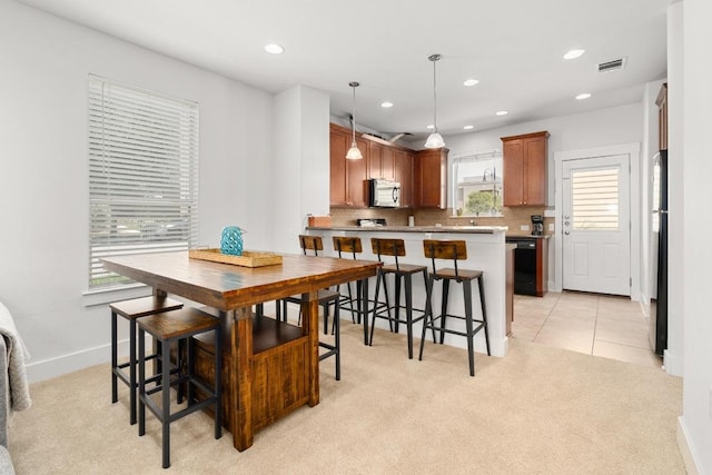 1601 Miriam Ave Unit 100, Austin, TX 78702 - dining space featuring light colored carpet, recessed lighting, and light tile patterned floors