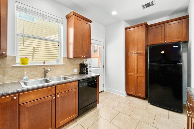 1601 Miriam Ave Unit 100, Austin, TX 78702 - kitchen featuring black appliances, tasteful backsplash, brown cabinets, and healthy amount of natural light
