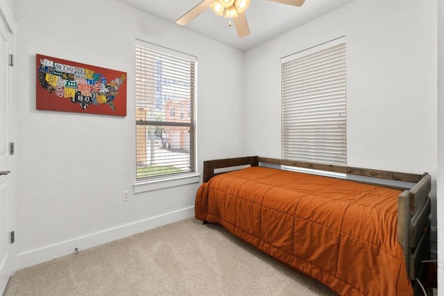 1601 Miriam Ave Unit 100, Austin, TX 78702 - bedroom with light colored carpet, multiple windows, and ceiling fan