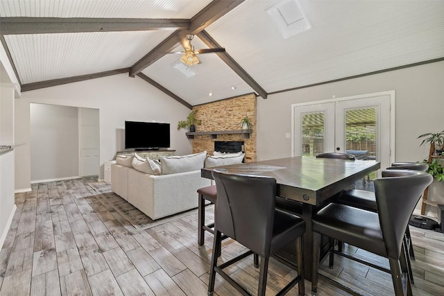 510 Heather Dr, Round Rock, TX 78664 - dining area featuring french doors, ceiling fan, light wood-type flooring, and a fireplace