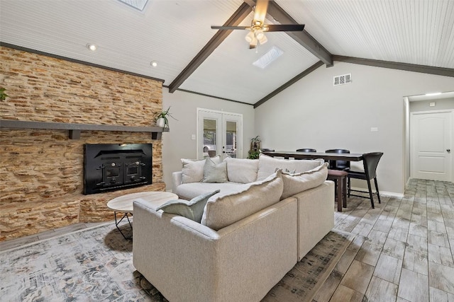 510 Heather Dr, Round Rock, TX 78664 - living room with wood finished floors, french doors, a ceiling fan, and a fireplace