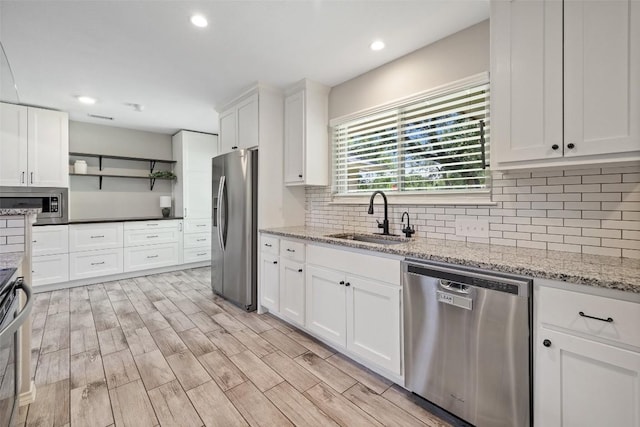 510 Heather Dr, Round Rock, TX 78664 - kitchen featuring stainless steel appliances, open shelves, white cabinets, backsplash, and recessed lighting