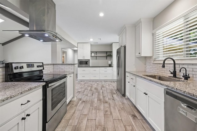 510 Heather Dr, Round Rock, TX 78664 - kitchen featuring appliances with stainless steel finishes, island exhaust hood, open shelves, backsplash, and recessed lighting